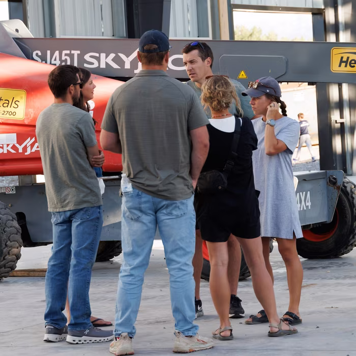 Church members talking near a construction lift